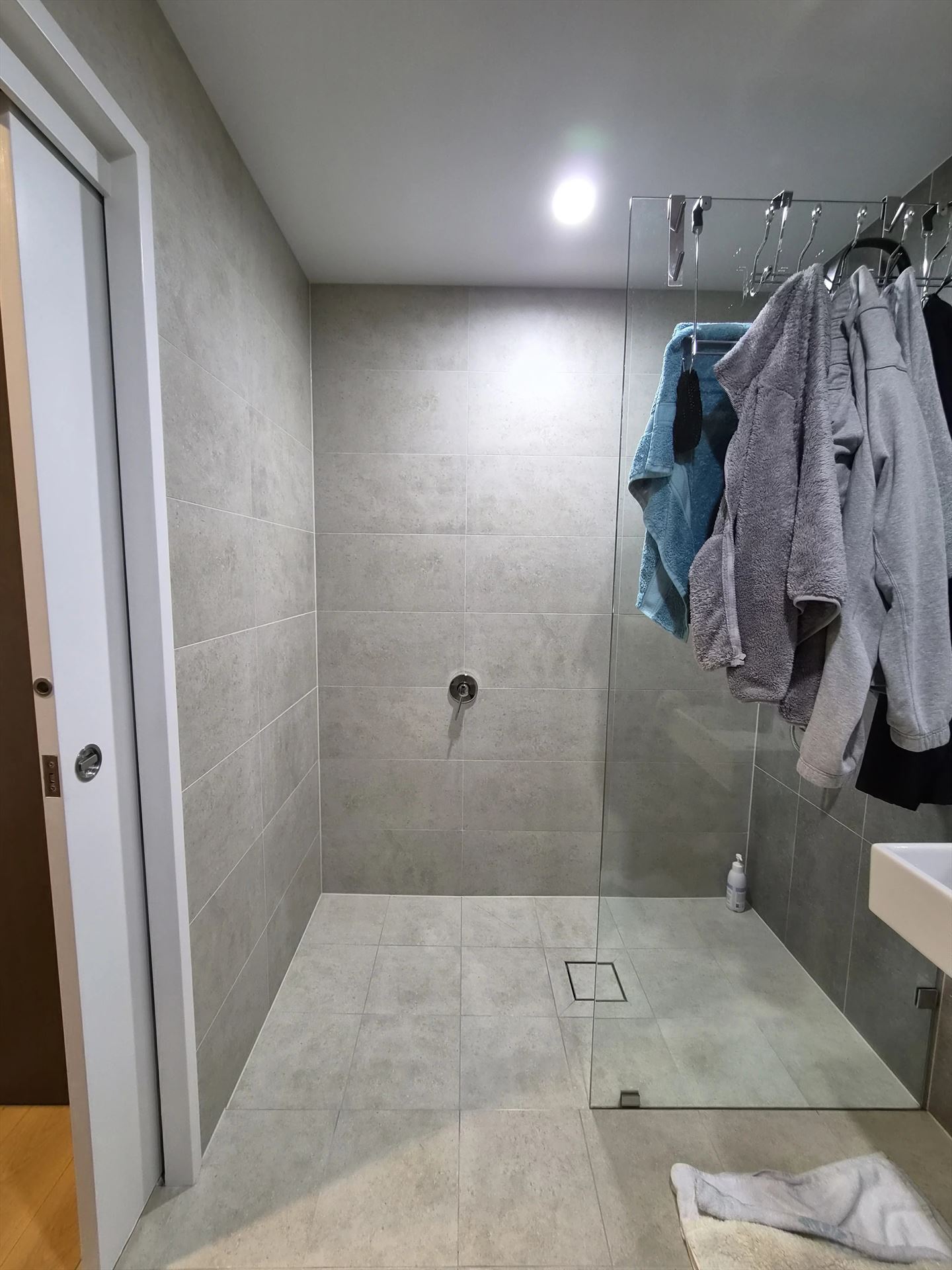 frameless shower screen with chrome hardware installed in Rouse Hill by Showerland
