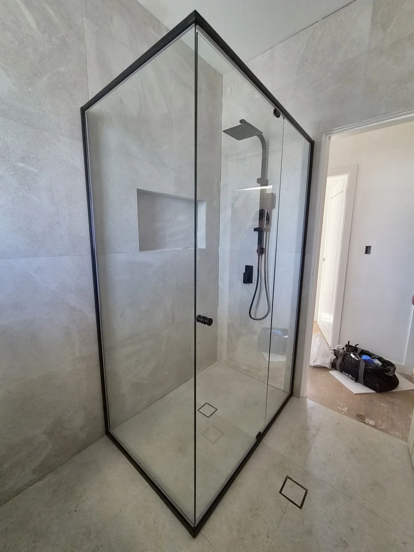 semi shower screen with black hardware installed in Kingswood by Showerland